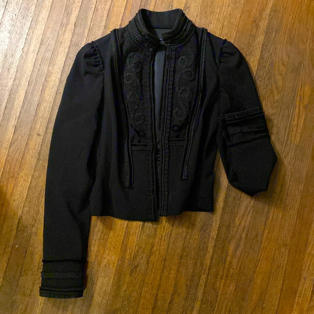 Vintage Shakespearean style jacket with hook closures.